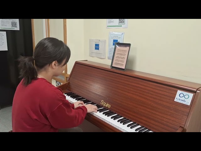 Claire Han plays the piano at the William Harvey Hospital 