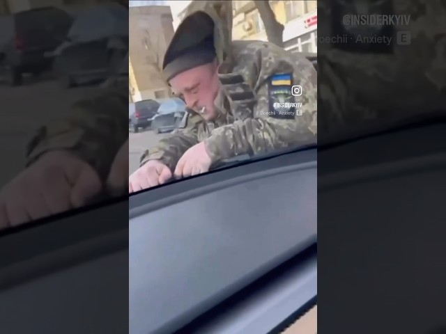 Tesla driver in Kyiv drove with a military enlistment worker on the hood—who still managed to smoke