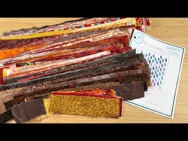 The STUNNING Shift quilt is made with leftover 2 1/2" strips or a Jelly Roll and background fabric!