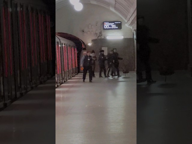 Moscow metro police carryng drunk passenger from subway train