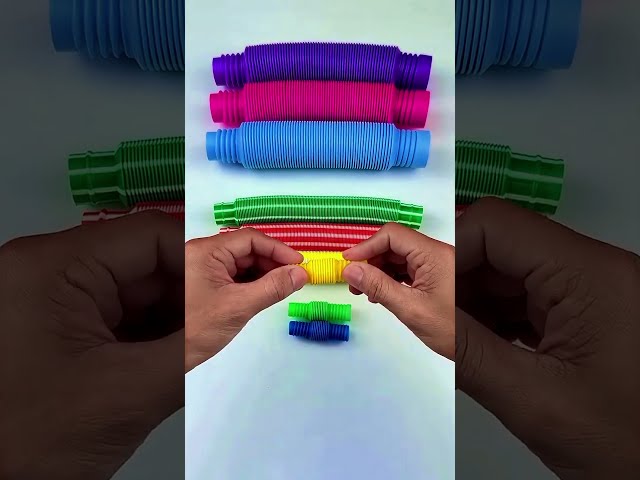 Colorful Pop Tubes Arranged into a Rainbow Pattern
