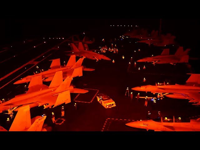 Intense And Dangerous Nighttime Flight Operations On Aircraft Carrier's Flight Deck