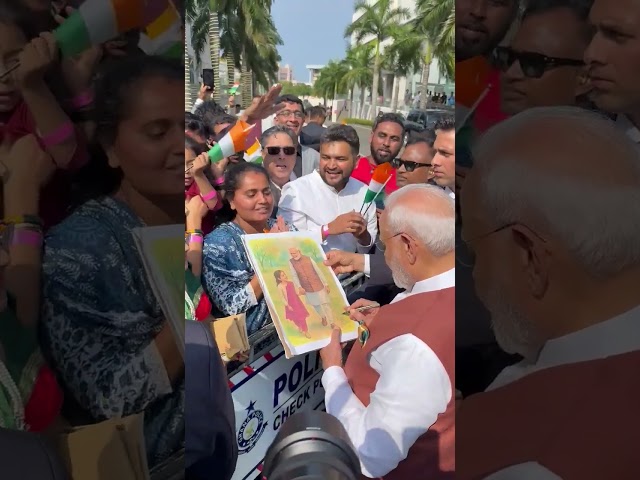Prime Minister Narendra Modi gives his autograph on a painting, Ghana