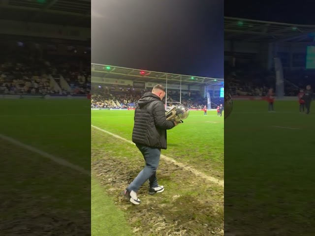 Luke Littler attends Warrington's match with the WDC trophy!