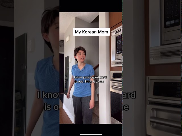 Older and Younger sibling gives report card to their korean mom