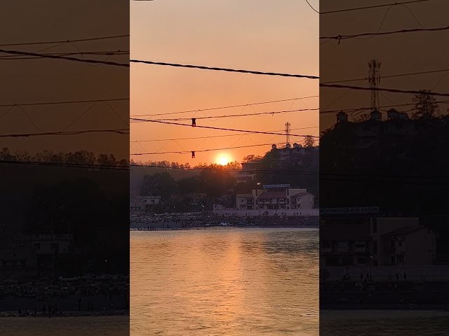 🌅 Golden sunset at the sacred banks of Maa Ganga near ❤️🙏Where the sky turns orange