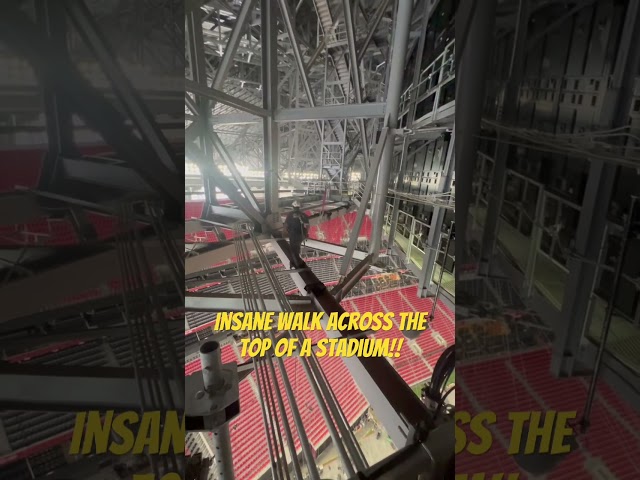 Could you walk across the top of a stadium? Travis can! #stadiumrigging #rigging #beamrigging
