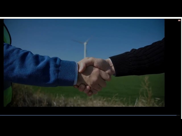 mixkit handshake against wind turbines 24249 medium 2