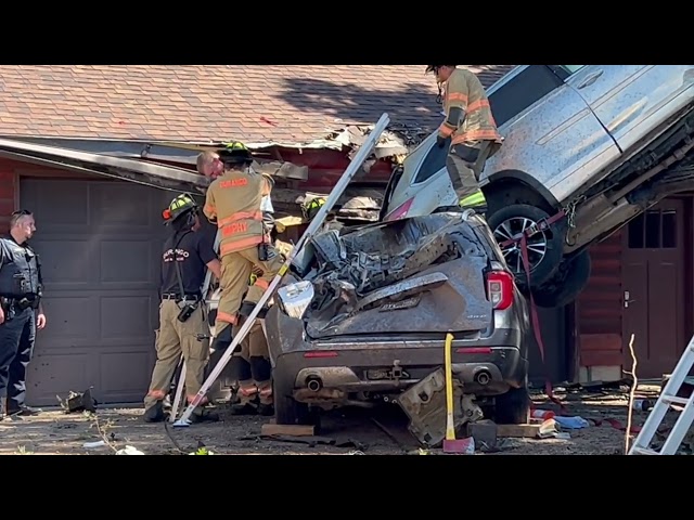 Toyota SUV lands on house, in tree