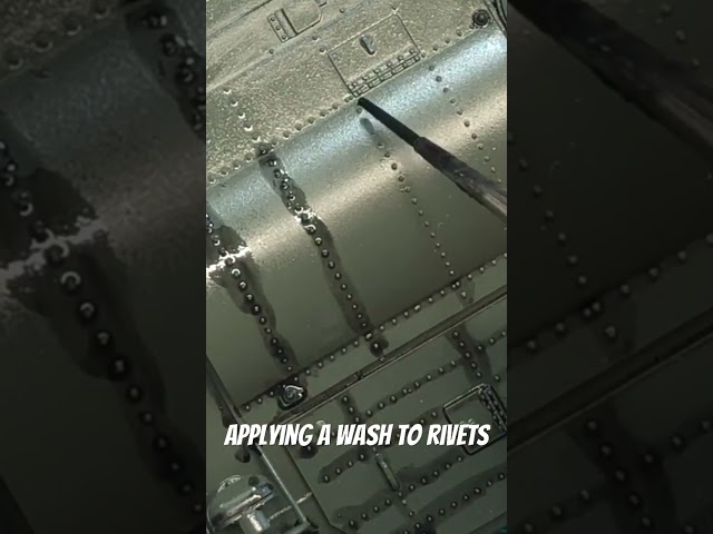 Applying a wash to rivets.