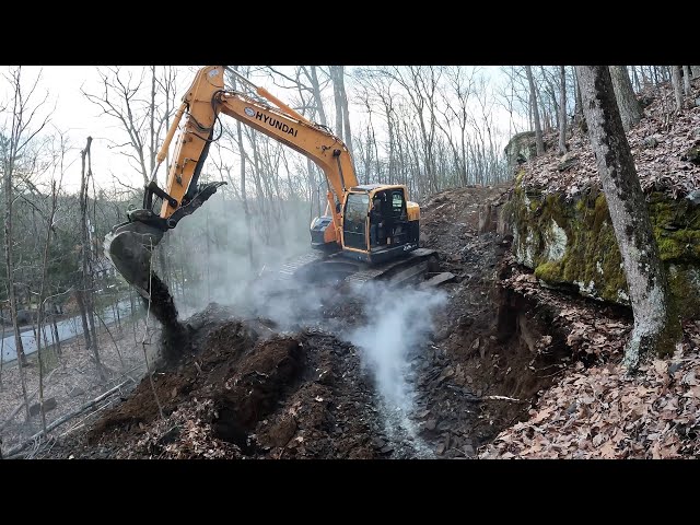 Digging in a driveway with a new excavator