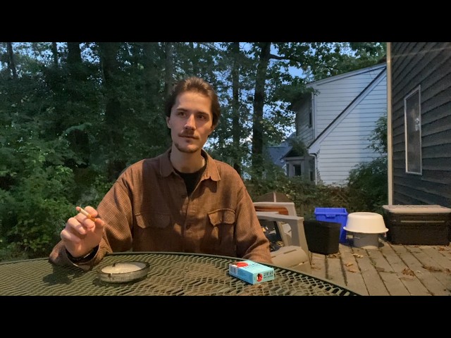 Smoking a Cigarette, but the Camera is on the Other Side of the Table