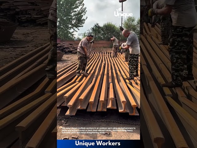 Industrial Processing: Workers Using Sledgehammers to Straighten Steel Railroad Tracks
