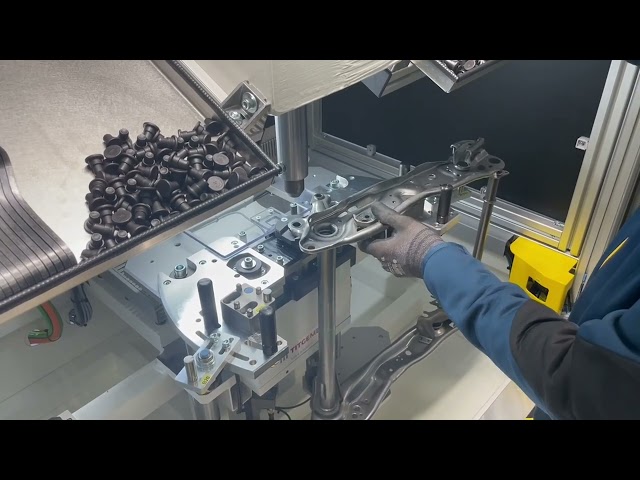 Machine for pressing a rivet into a gear rack and a rear tube assembly.