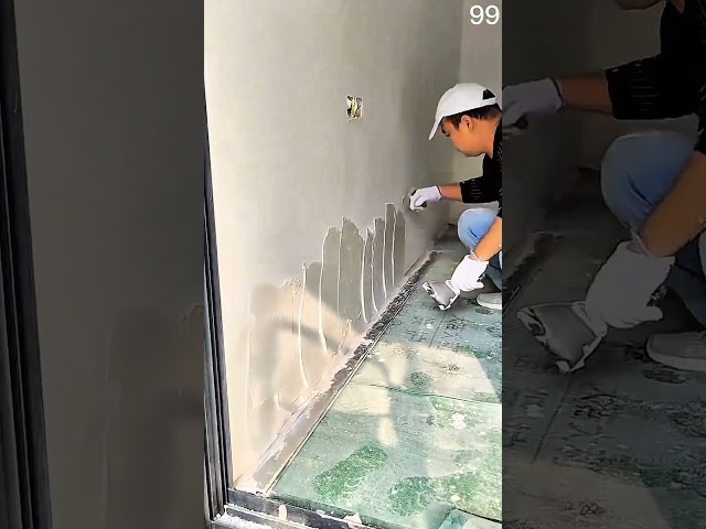 trowel spreads plaster smoothly around a wall outlet #plastering #construction